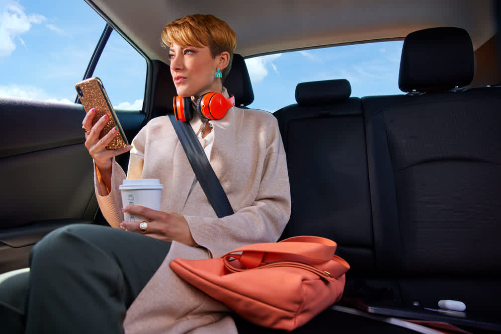 Business professional passenger in the backseat of a Lyft ride.