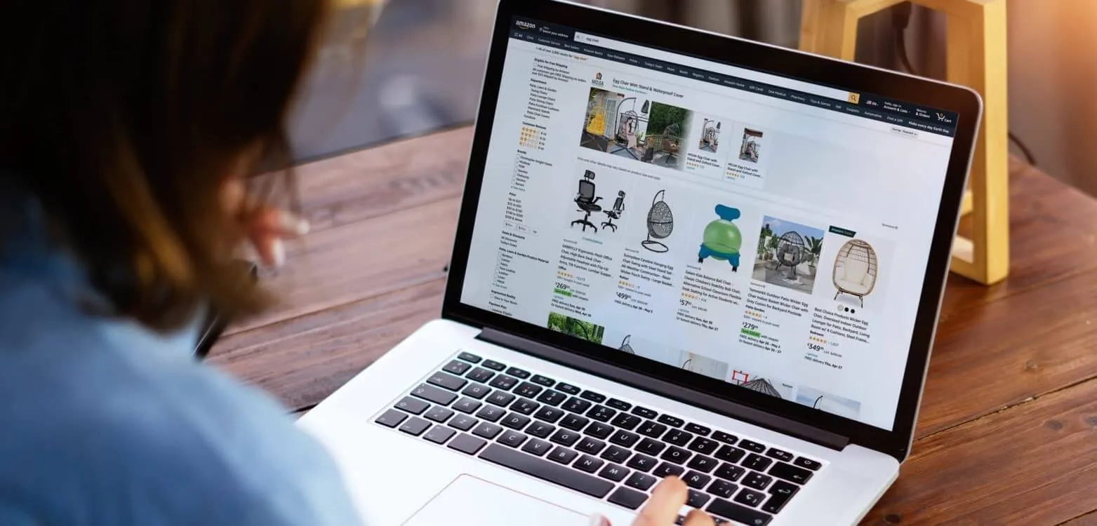 Someone browsing furniture on Amazon via a laptop